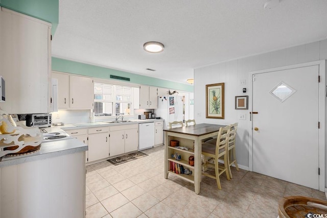 kitchen with white cabinets, white appliances, a textured ceiling, and sink