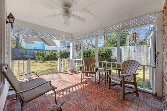 sunroom / solarium featuring ceiling fan