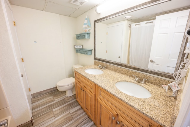 4800 S Ocean Blvd Unit 1522, North Myrtle Beach, SC 29582 - bathroom with double vanity, toilet, a shower with shower curtain, and a drop ceiling
