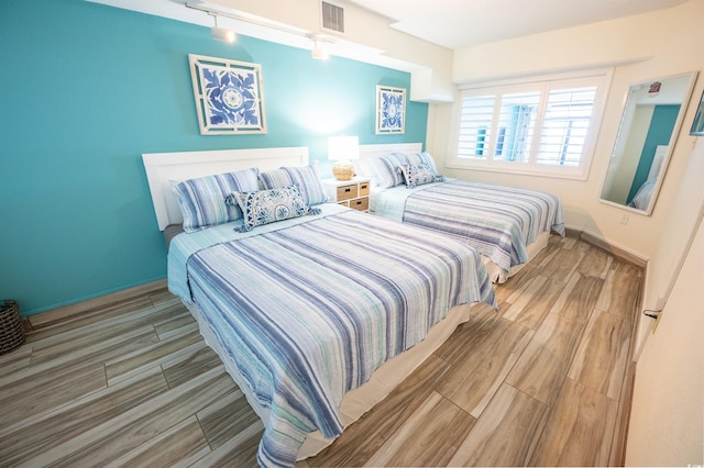 4800 S Ocean Blvd Unit 1522, North Myrtle Beach, SC 29582 - bedroom featuring wood finished floors and baseboards
