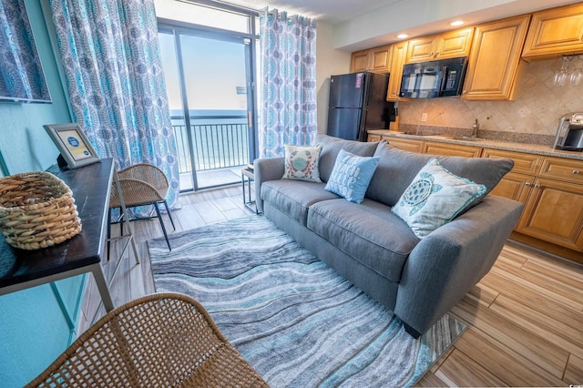 4800 S Ocean Blvd Unit 1522, North Myrtle Beach, SC 29582 - living room featuring light wood-style floors, healthy amount of natural light, and wet bar