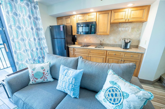 4800 S Ocean Blvd Unit 1522, North Myrtle Beach, SC 29582 - kitchen with black appliances, backsplash, a sink, baseboards, and recessed lighting