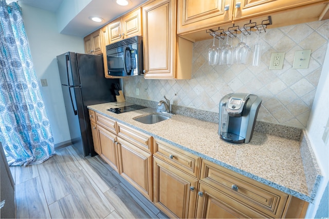 4800 S Ocean Blvd Unit 1522, North Myrtle Beach, SC 29582 - kitchen featuring black appliances, a sink, light stone counters, tasteful backsplash, and baseboards