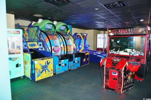 recreation room with dark colored carpet and a paneled ceiling