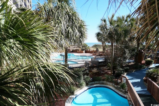 view of pool featuring a water view