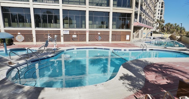 4800 S Ocean Blvd Unit 1522, North Myrtle Beach, SC 29582 - community pool featuring a patio area and a hot tub