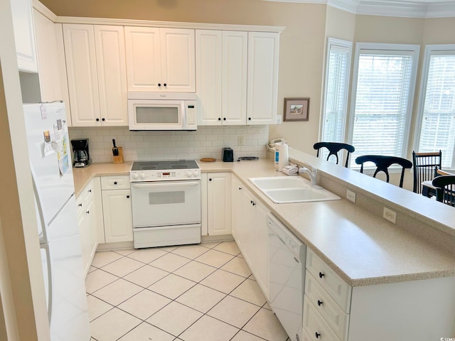 kitchen with white cabinetry, sink, white appliances, and ornamental molding