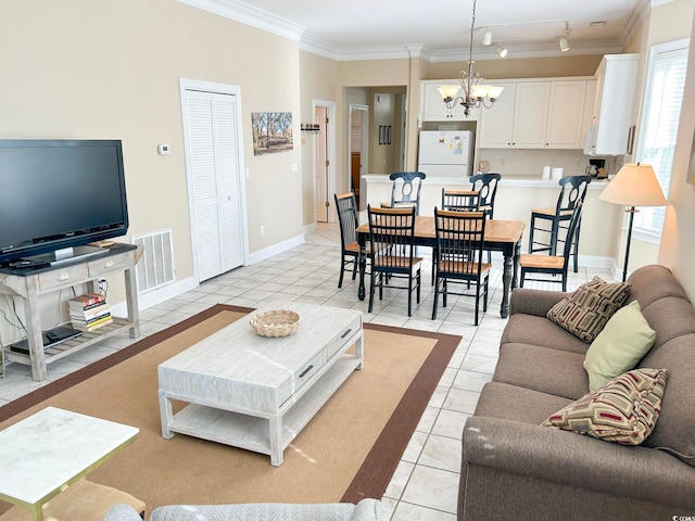 living room featuring an inviting chandelier, ornamental molding, and light tile patterned floors