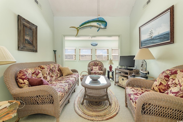 living room featuring vaulted ceiling and carpet