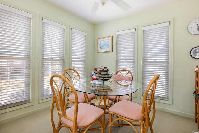 dining area featuring light colored carpet and ceiling fan