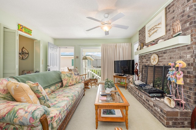 carpeted living room featuring a brick fireplace, a textured ceiling, and ceiling fan