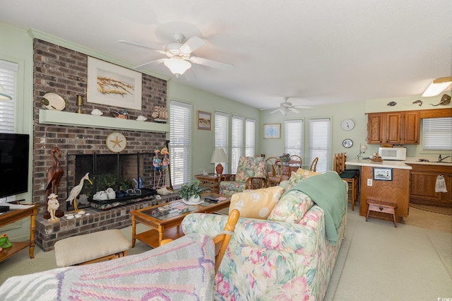 carpeted living room featuring a fireplace and ceiling fan