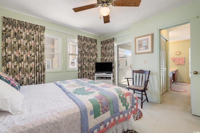 206 56th Ave N, North Myrtle Beach, SC 29582 - bedroom featuring carpet floors, multiple windows, a textured ceiling, a ceiling fan, and connected bathroom