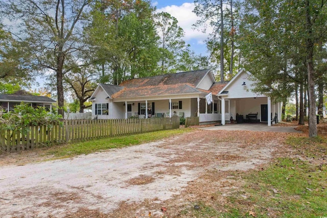 view of front of house featuring a carport and covered porch