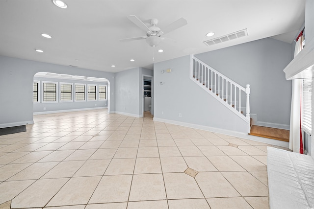 unfurnished living room featuring ceiling fan and light tile patterned floors