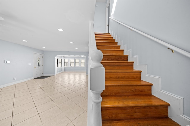 staircase featuring tile patterned flooring