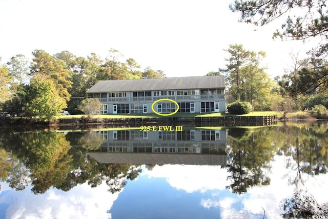 rear view of property with a water view