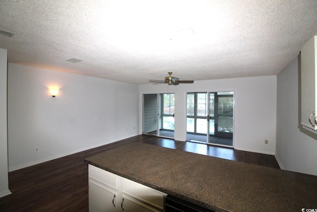 kitchen with dark hardwood / wood-style flooring, a textured ceiling, and ceiling fan