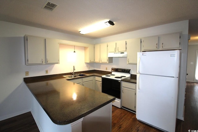 kitchen with a textured ceiling, white appliances, sink, dark wood-type flooring, and kitchen peninsula