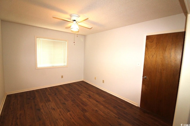 spare room with dark hardwood / wood-style flooring, a textured ceiling, and ceiling fan