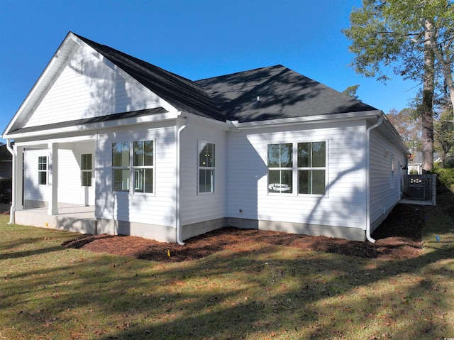 rear view of property with a lawn