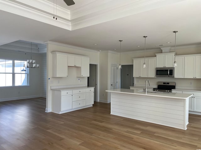 kitchen with white cabinetry, an island with sink, pendant lighting, and appliances with stainless steel finishes