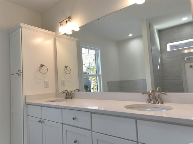 bathroom with vanity and tiled shower