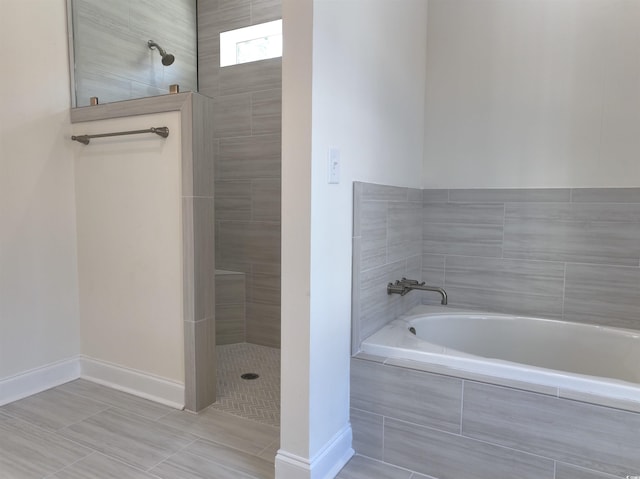 bathroom featuring independent shower and bath