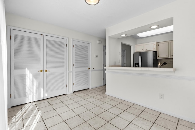 2925 Carriage Row Ln Unit 134, Myrtle Beach, SC 29577 - kitchen with stainless steel fridge, a peninsula, and light tile patterned floors