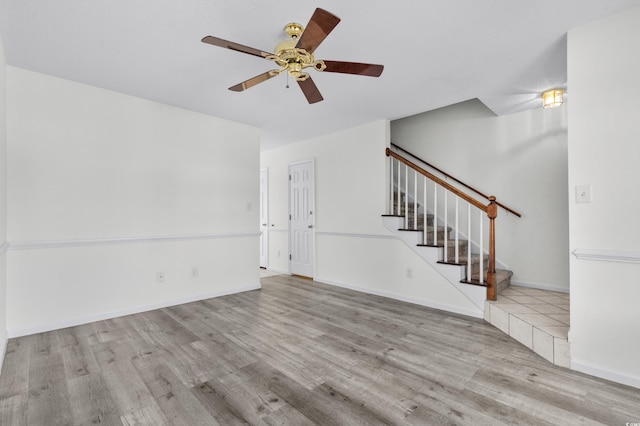 2925 Carriage Row Ln Unit 134, Myrtle Beach, SC 29577 - unfurnished living room with wood finished floors, stairway, and ceiling fan