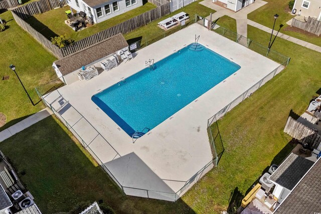 view of swimming pool with a yard and a patio