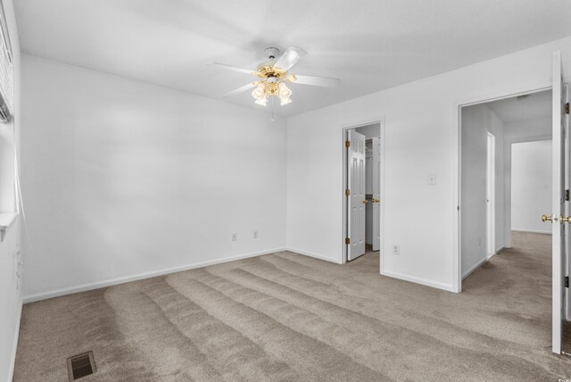 2925 Carriage Row Ln Unit 134, Myrtle Beach, SC 29577 - unfurnished bedroom featuring carpet, a spacious closet, a ceiling fan, and a closet