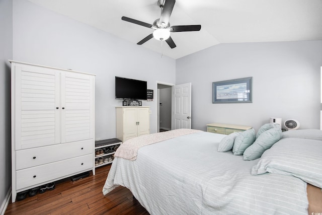 bedroom featuring lofted ceiling, dark hardwood / wood-style flooring, and ceiling fan