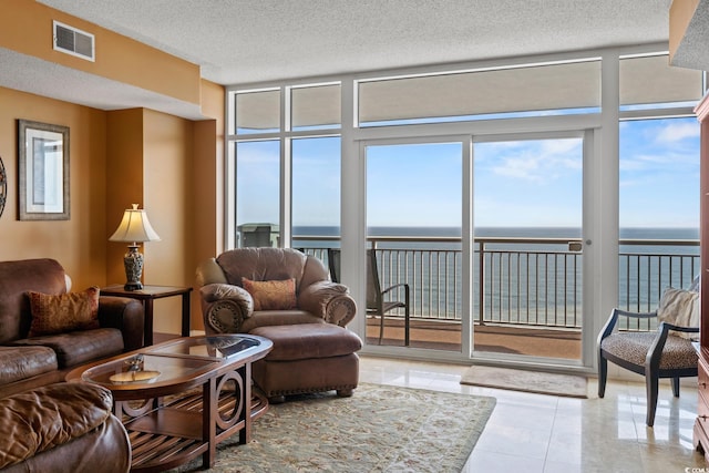 2709 Ocean Blvd S Unit 1202, Myrtle Beach, SC 29577 - living room with expansive windows, a water view, a textured ceiling, and tile patterned floors