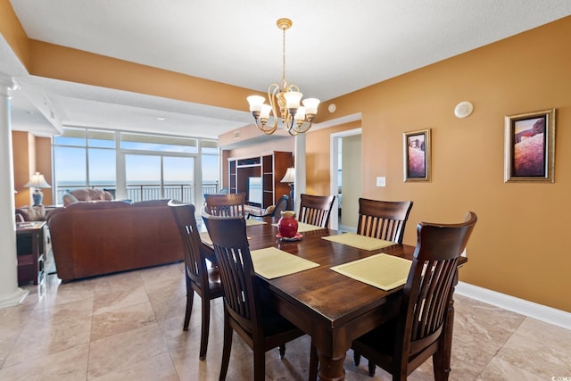 2709 Ocean Blvd S Unit 1202, Myrtle Beach, SC 29577 - dining area with a chandelier and baseboards