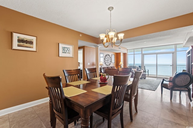2709 Ocean Blvd S Unit 1202, Myrtle Beach, SC 29577 - dining room with a chandelier, a water view, light tile patterned floors, floor to ceiling windows, and baseboards