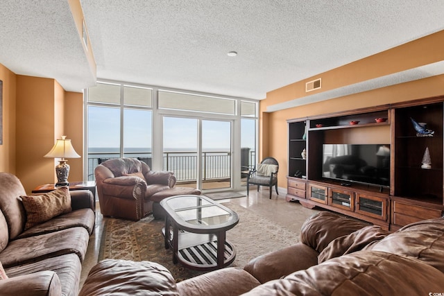 living room with a wall of windows and a textured ceiling