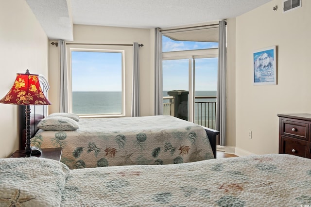 2709 Ocean Blvd S Unit 1202, Myrtle Beach, SC 29577 - bedroom with access to exterior, a water view, baseboards, and wood finished floors