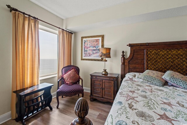 2709 Ocean Blvd S Unit 1202, Myrtle Beach, SC 29577 - bedroom featuring wood finished floors and baseboards