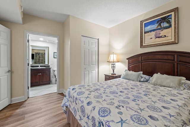2709 Ocean Blvd S Unit 1202, Myrtle Beach, SC 29577 - bedroom with light wood-style flooring, baseboards, and ensuite bathroom