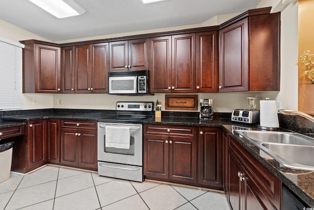 2709 Ocean Blvd S Unit 1202, Myrtle Beach, SC 29577 - kitchen with appliances with stainless steel finishes, a sink, light tile patterned flooring, and dark stone counters