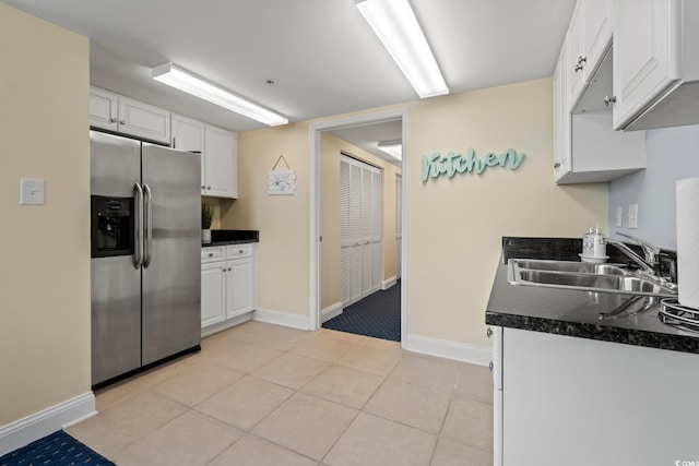 2709 Ocean Blvd S Unit 1202, Myrtle Beach, SC 29577 - kitchen with stainless steel refrigerator with ice dispenser, a sink, dark countertops, baseboards, and white cabinetry