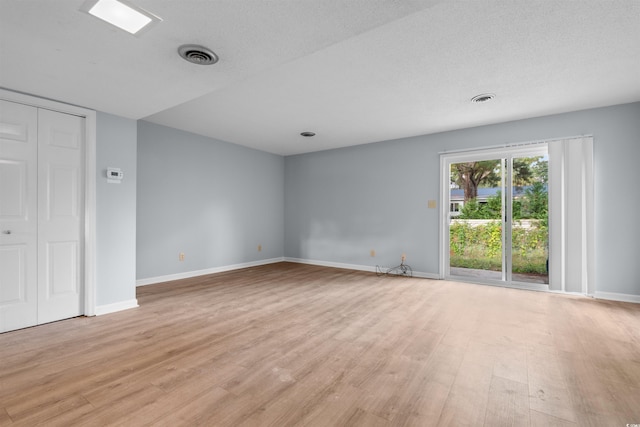 interior space featuring light hardwood / wood-style floors and a textured ceiling