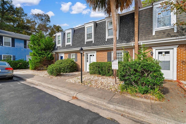 4505 N Kings Hwy Unit C3, Myrtle Beach, SC 29577 - view of property with mansard roof, roof with shingles, and brick siding