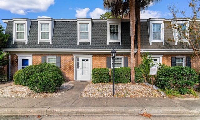 4505 N Kings Hwy Unit C3, Myrtle Beach, SC 29577 - view of front of home with mansard roof, roof with shingles, and brick siding