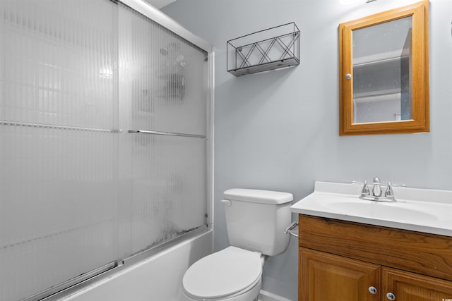 full bathroom featuring combined bath / shower with glass door, vanity, and toilet