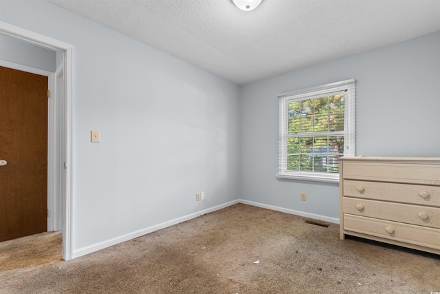 unfurnished bedroom featuring carpet flooring and a textured ceiling