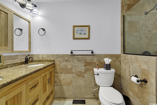 153 Garden Ave, Georgetown, SC 29440 - full bathroom with tile walls, toilet, double vanity, wainscoting, and a tile shower