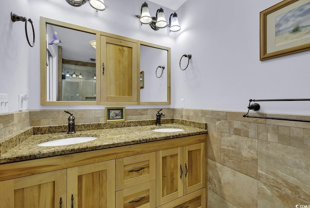 153 Garden Ave, Georgetown, SC 29440 - bathroom with a stall shower, double vanity, tile walls, and wainscoting