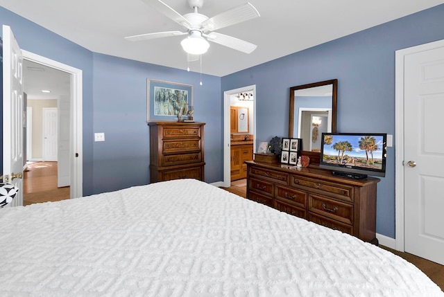 bedroom featuring ceiling fan and ensuite bath